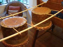 panettone hanging from dowels suspended between chairs