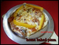 home baked pizza topped with capsicum and cheese